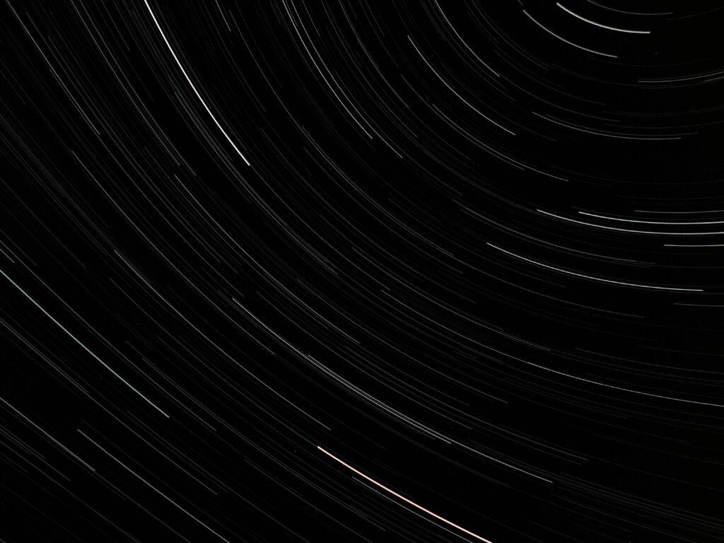 Mesmerizing Star Trails Wallpaper - Captivating Long Exposure Background