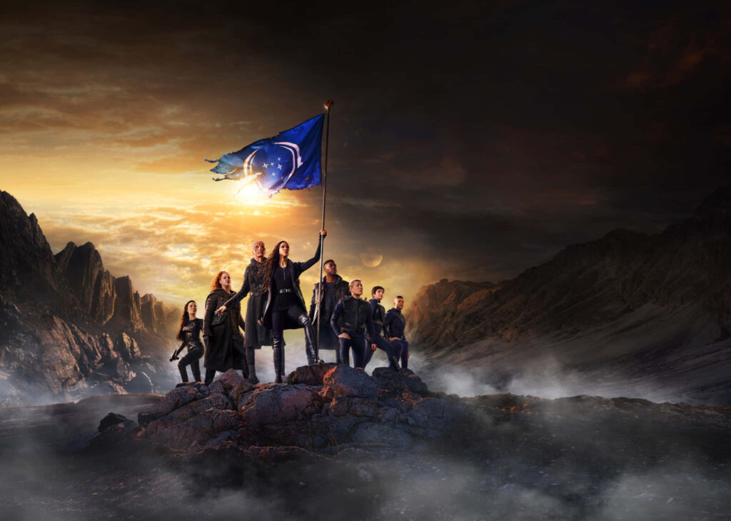 Star Trek Crew Unity Wallpaper: Iconic Starfleet Flag & Dramatic Sky