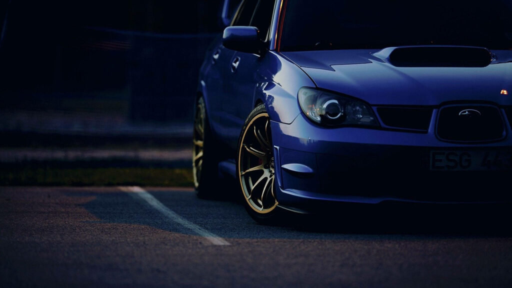 Sleek Subaru Impreza Wallpaper with Gold Rims - Sporty Background