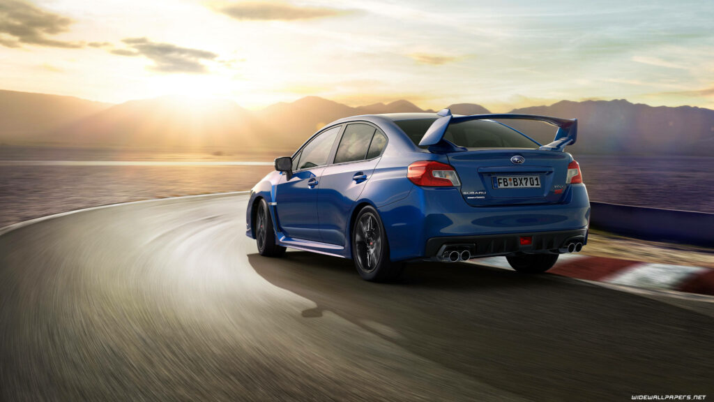 Stunning Subaru Impreza Wallpaper: Speeding on a Sunlit Racetrack