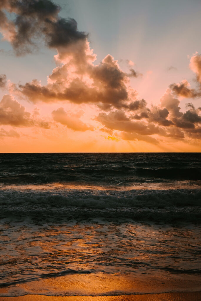 Stunning Sunset Beach with Dramatic Clouds and Golden Waves Reflection Wallpaper