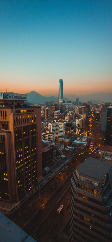 Stunning Sunset Cityscape Wallpaper: Tall Buildings & Glowing Lights