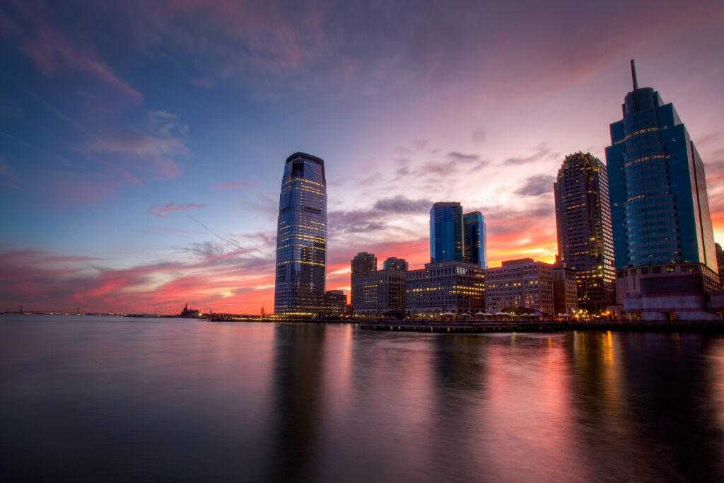 Stunning Sunset Cityscape Wallpaper with Reflective Water