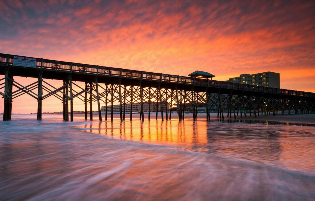 Serene Sunset Over Pier: Warm Hues & Gentle Waves - Tranquil Wallpaper