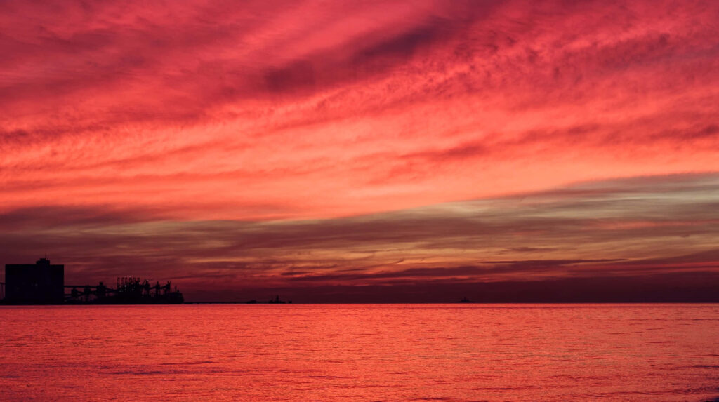 Vibrant Sunset Sea Landscape: Red and Orange Sky Over Tranquil Waters Wallpaper