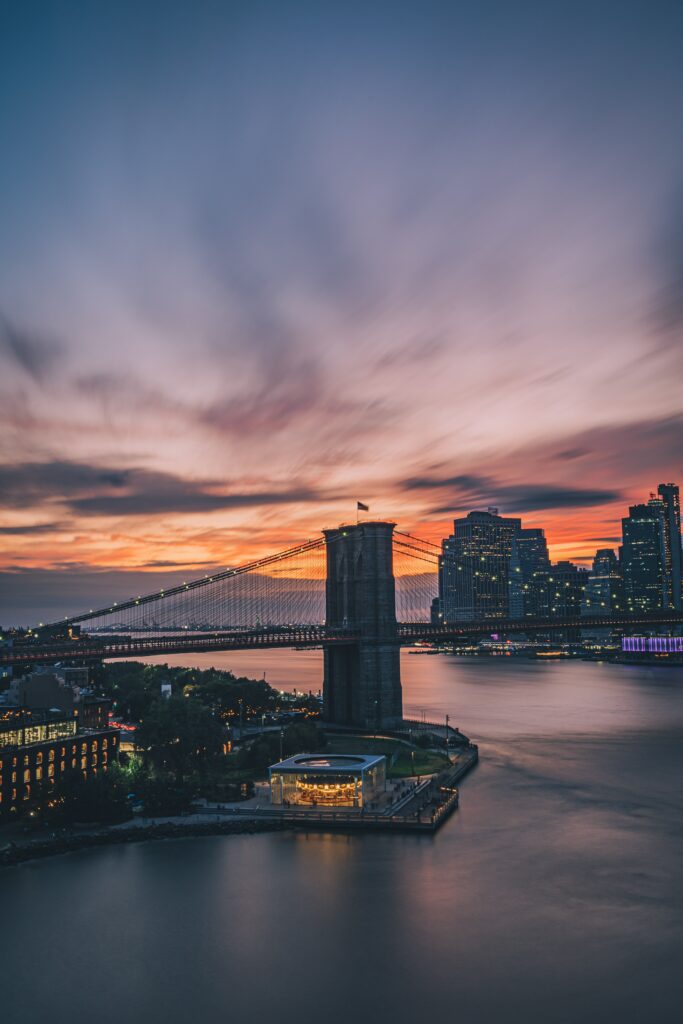 Stunning Wallpaper: Serene Bridge Over Calm Waters at Sunset