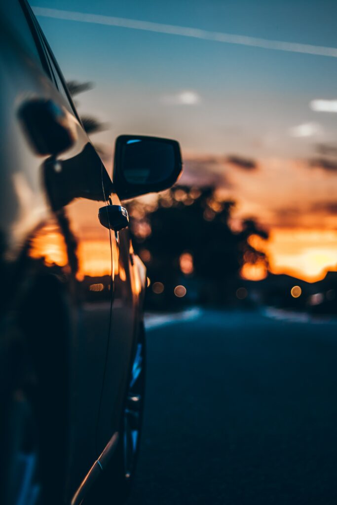 Stunning Car in Motion at Sunset - Vibrant Wallpaper Background
