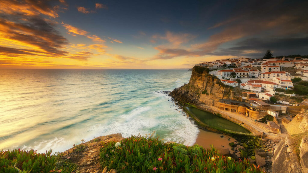 Stunning Coastal Sunset Wallpaper Over Rugged Cliffs & Serene Beach