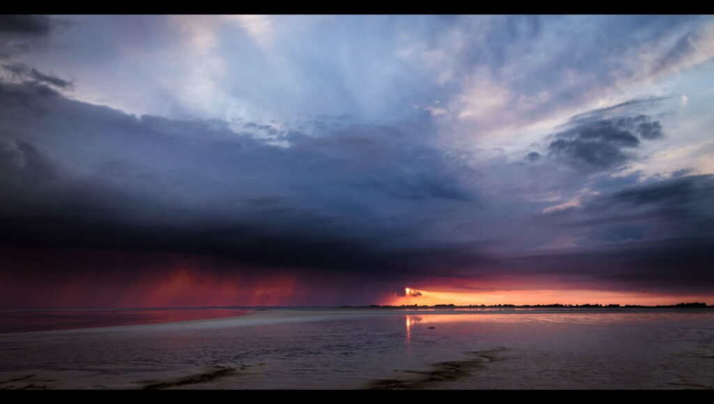 Stunning Sunset Over Beach: Dramatic Storm Clouds HD Wallpaper