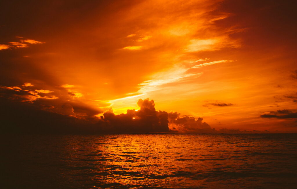Stunning Sunset Over Tranquil Sea with Vibrant Sky Hues Wallpaper