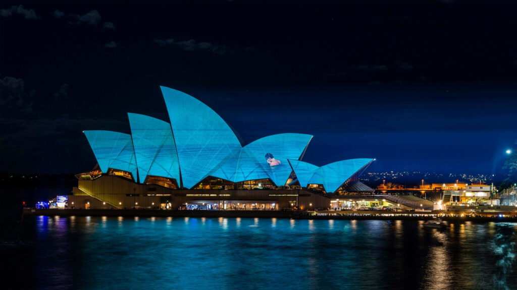 Stunning Sydney Opera House Night View: Vibrant Blue Wallpaper