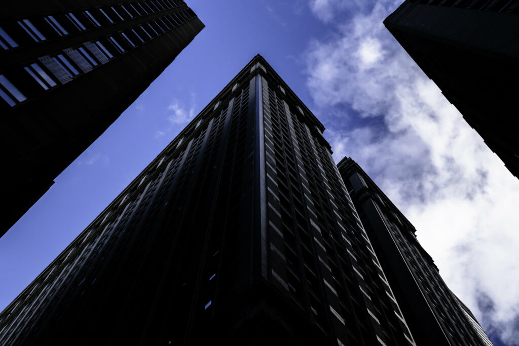 Stunning Bottom-Up View of Tall Buildings Wallpaper Background