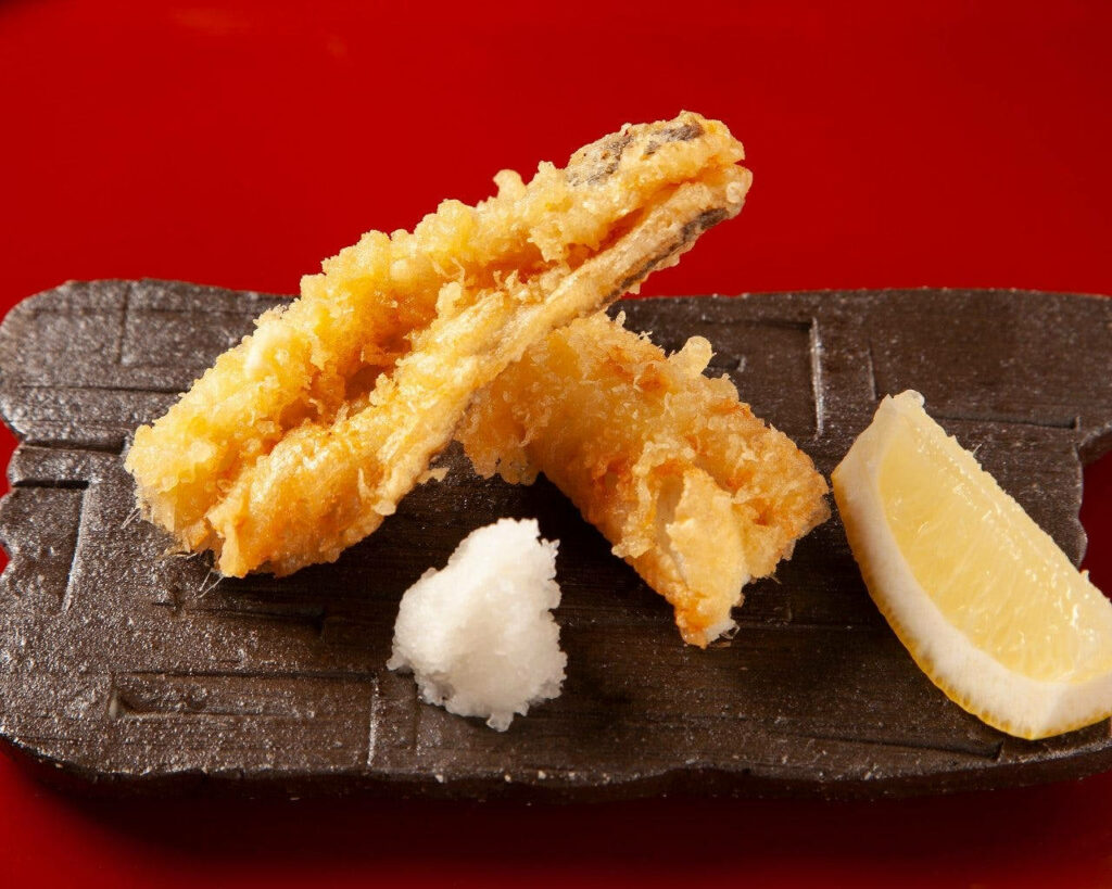 Stunning Tempura Close-Up: Crispy Delights on Vibrant Red Wallpaper