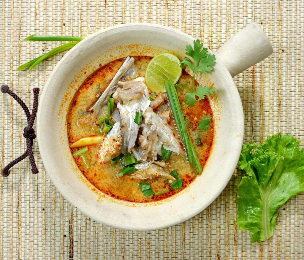 Vibrant Thai Fish Head Curry Flat Lay: Rustic Wallpaper Background