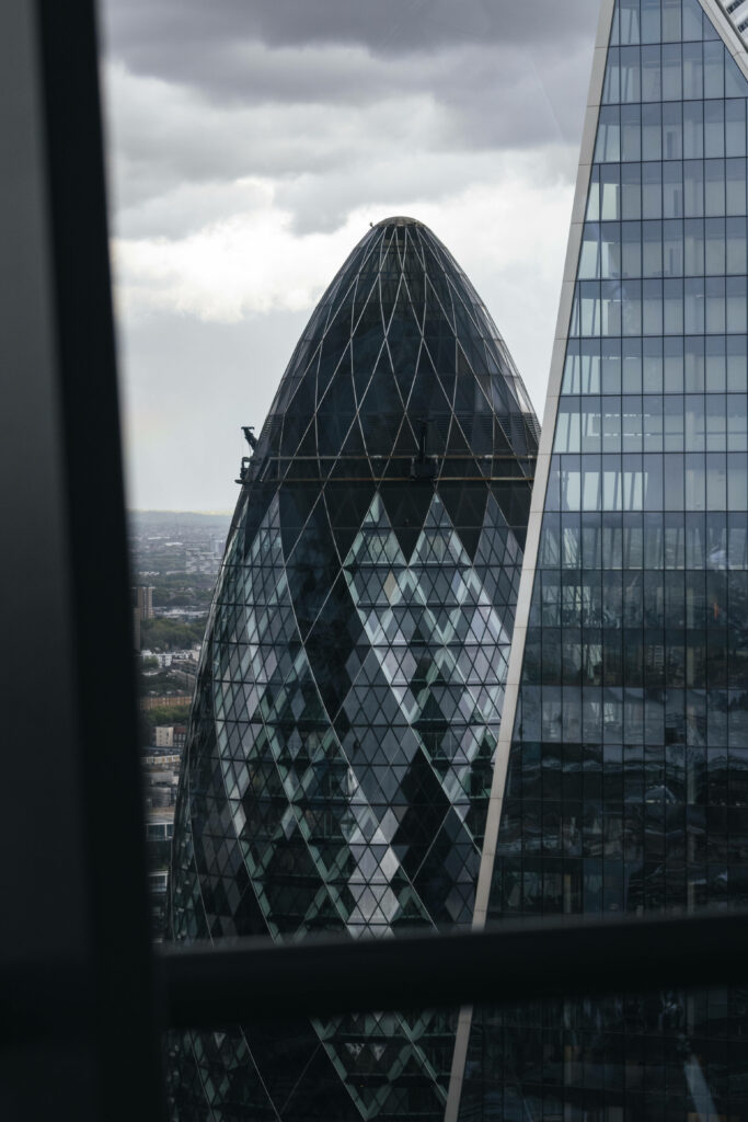 Stunning Gherkin Architecture: Glass Exterior Against Cloudy Sky Wallpaper