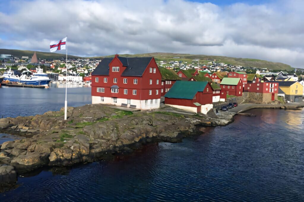 Scenic Tinganes Wallpaper: Historic Red Buildings & Faroe Islands Flag