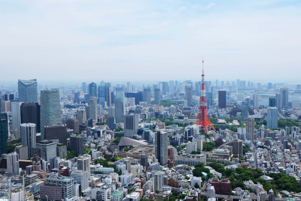 Stunning Tokyo Cityscape Wallpaper with Iconic Tower & Blue Sky