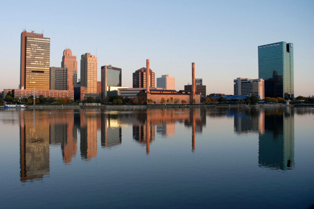 Stunning Toledo Cityscape Wallpaper: Reflections on Calm Waterfront