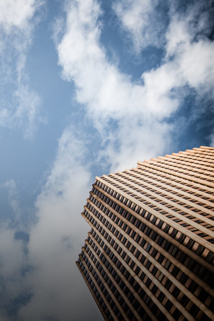 Modern Skyscraper Wallpaper: Stunning Bottom Perspective with Blue Sky