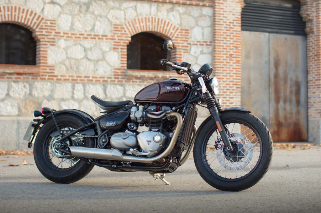 Stunning Triumph Motorcycle Wallpaper: Rustic Brick & Stone Background