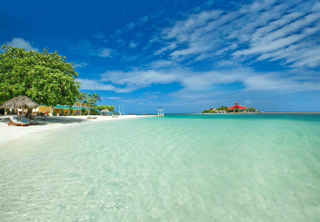 Tropical Paradise Wallpaper: Tranquil Beach & Lush Greenery Background