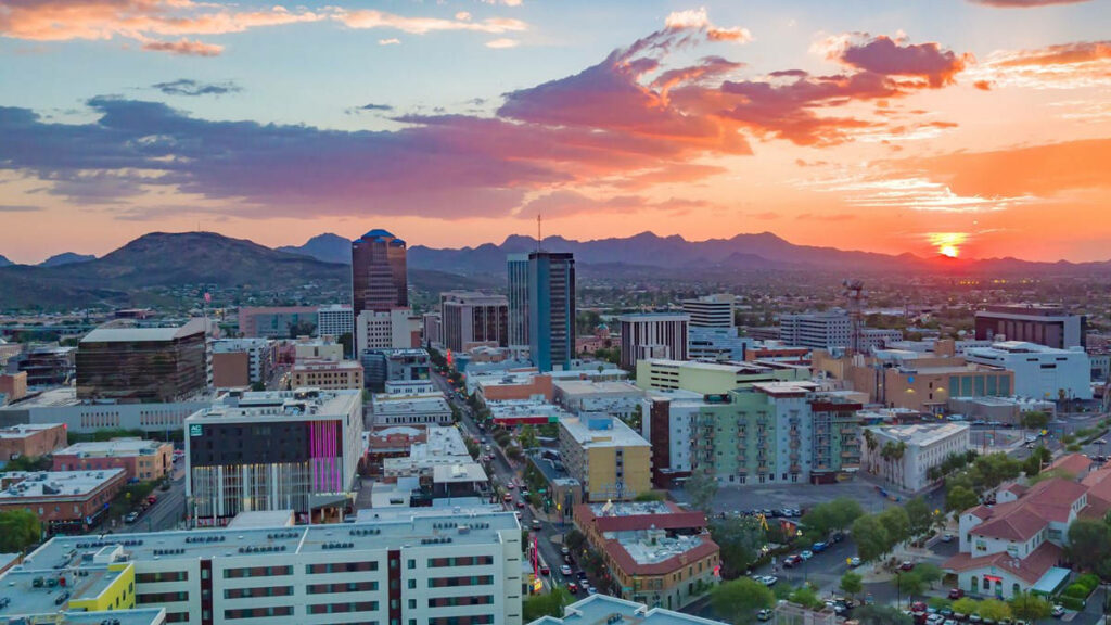 Stunning Tucson Aerial View: Modern Cityscape & Mountain Sunset Wallpaper