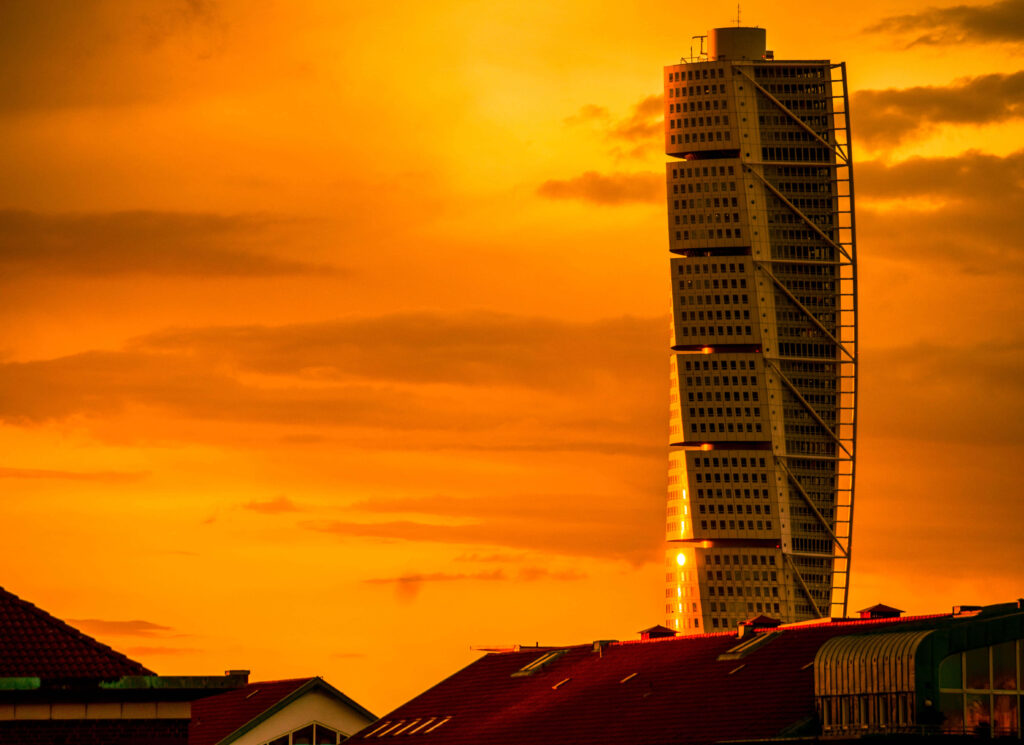 Stunning Turning Torso Wallpaper Against Vibrant Orange Sunset Sky