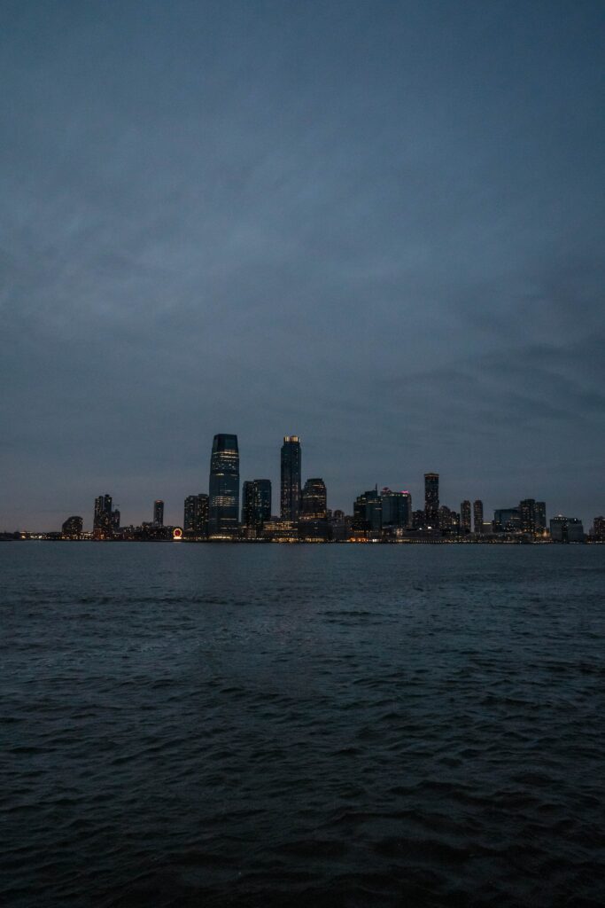Twilight Cityscape Wallpaper: Modern Buildings Illuminated by Water