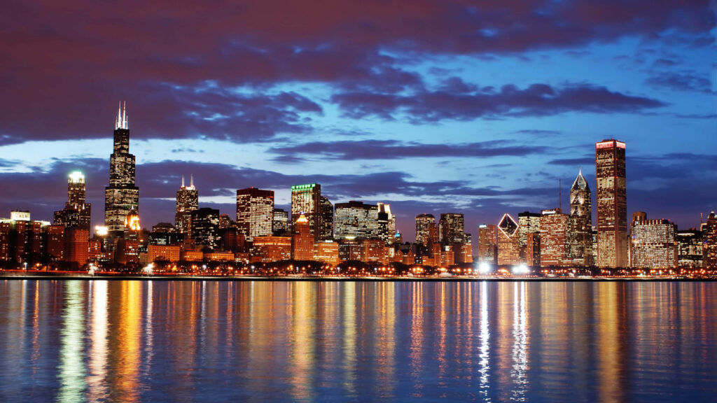 Twilight Cityscape: Vibrant Skyline Wallpaper with Shimmering Reflections
