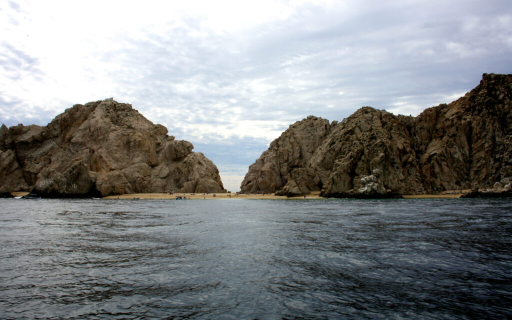 Stunning Twin Rock Formations: Beach Wallpaper with Serene Ocean View
