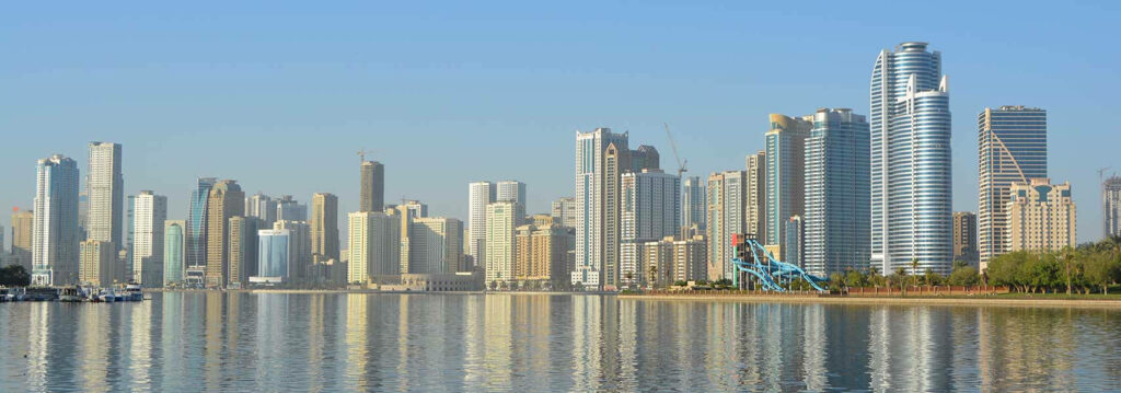 UAE Skyline Wallpaper: Modern Skyscrapers Reflecting on Calm Waters