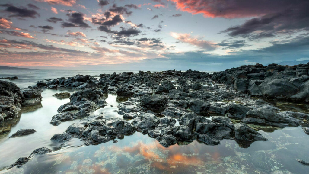 Stunning Ultra HD Beach Wallpaper with Rugged Rocks & Dramatic Sky