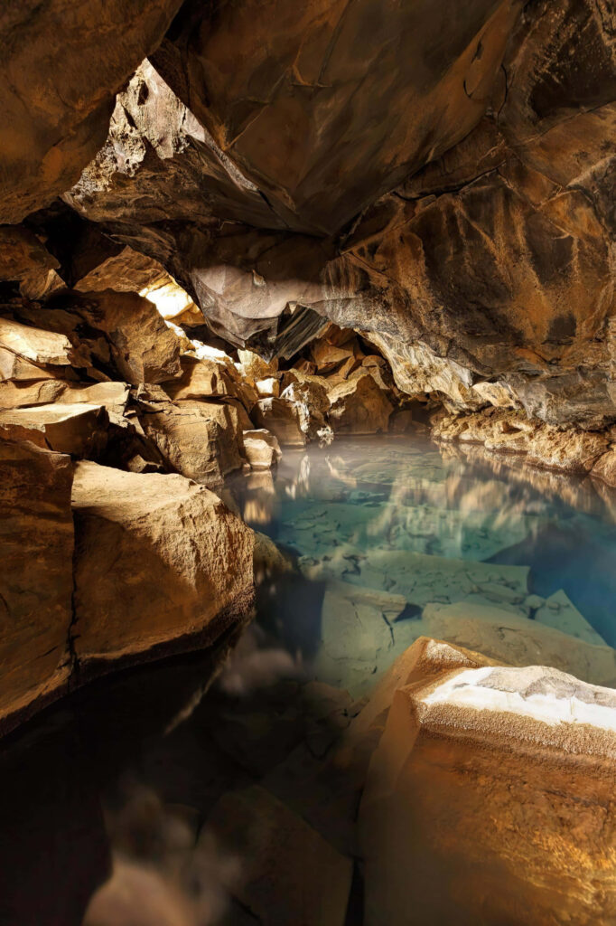 Tranquil Underground Cave Wallpaper: Crystal-Clear Water & Rocky Formations