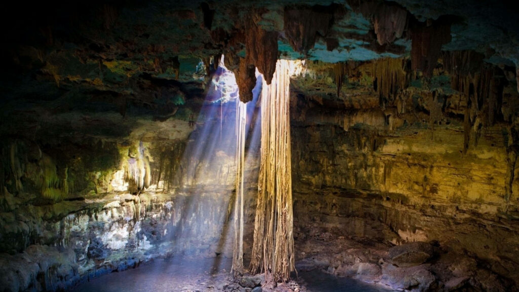 Stunning Underground Cave Wallpaper with Ethereal Sunlight Glow