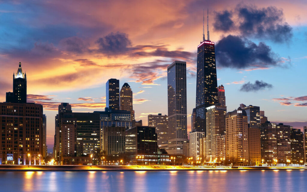 Stunning Cityscape Wallpaper: Skyscrapers & Colorful Sunset Reflections
