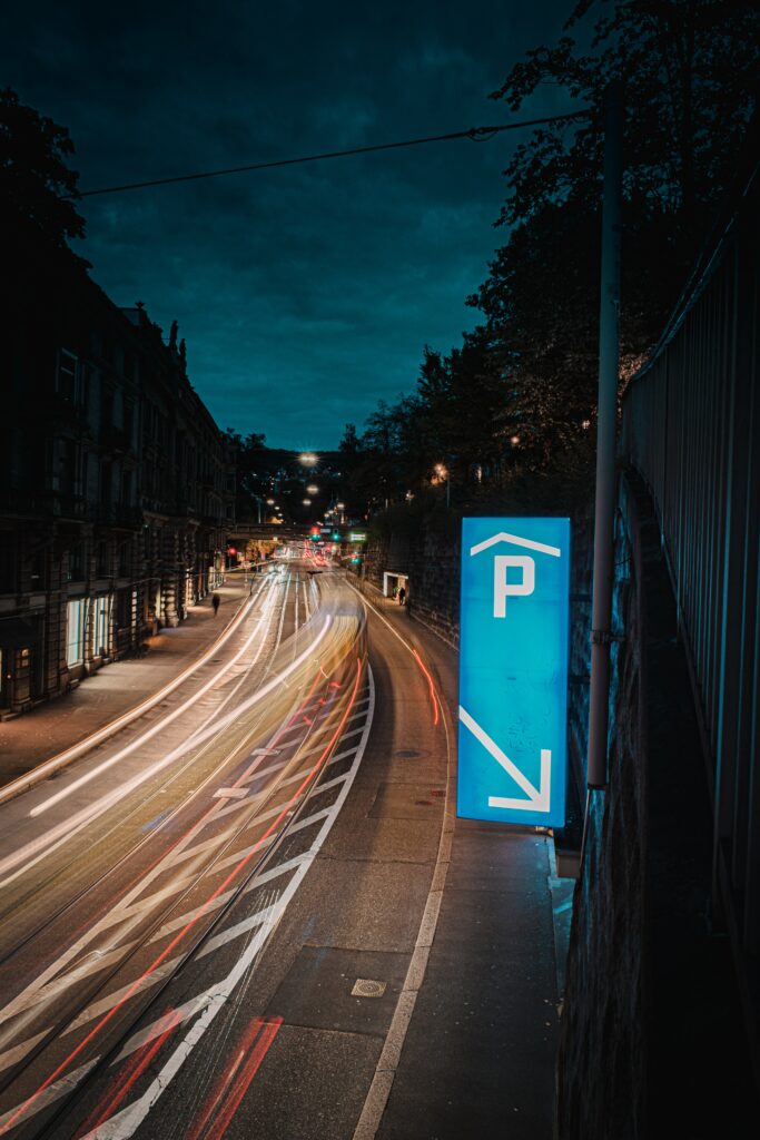 Stunning Urban Nightscape Wallpaper with Neon Parking Sign