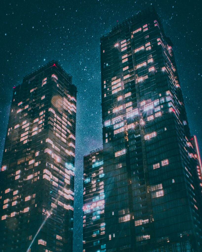 Stunning Urban Wallpaper: Towering Buildings & Starry Night Sky