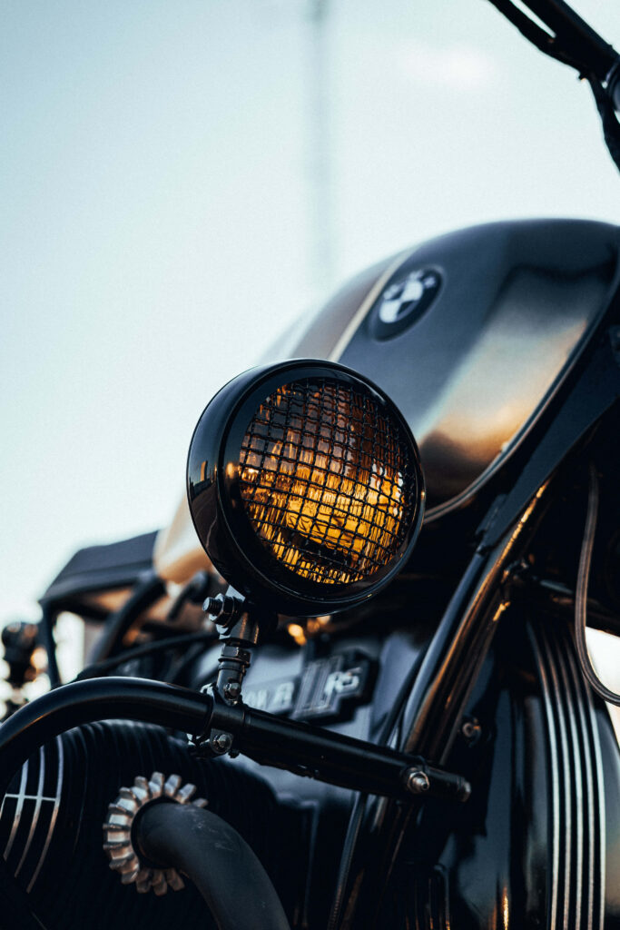 Vintage Motorcycle Close-Up Wallpaper with Glowing Yellow Headlight