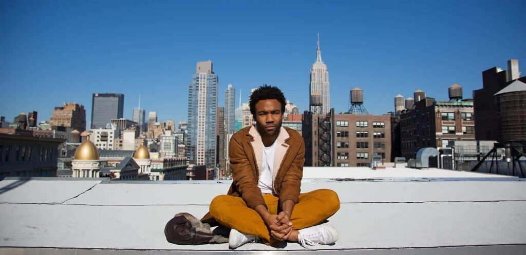 Donald Glover Rooftop Wallpaper: Cityscape & Clear Blue Skies