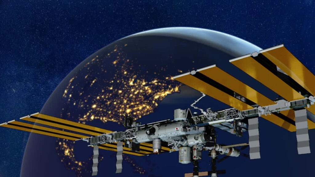 Stunning Wallpaper: ISS Orbiting Earth with Starry Sky Background