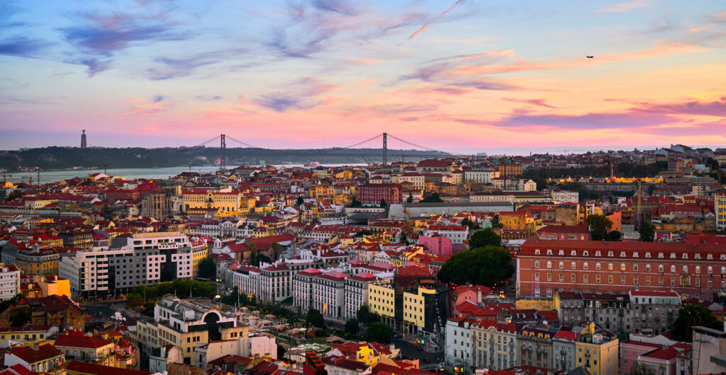 Vibrant Lisbon Sunset Wallpaper: Colorful Cityscape & 25 de Abril Bridge