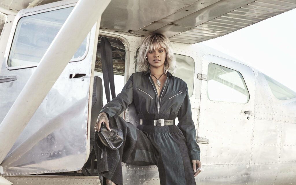 Rihanna's Bold Style: Stunning Wallpaper with Sleek Metal Plane