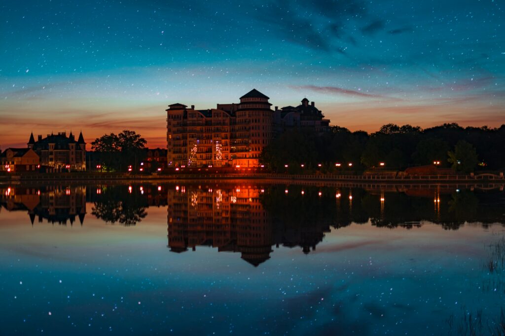 Serene Wallpaper: Elegant Building Reflection Under Starry Sky
