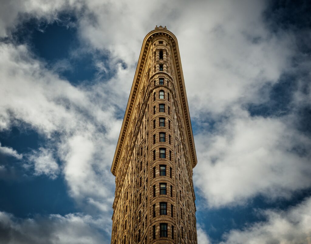 Stunning Wallpaper of Iconic Triangular Building Against Dramatic Sky