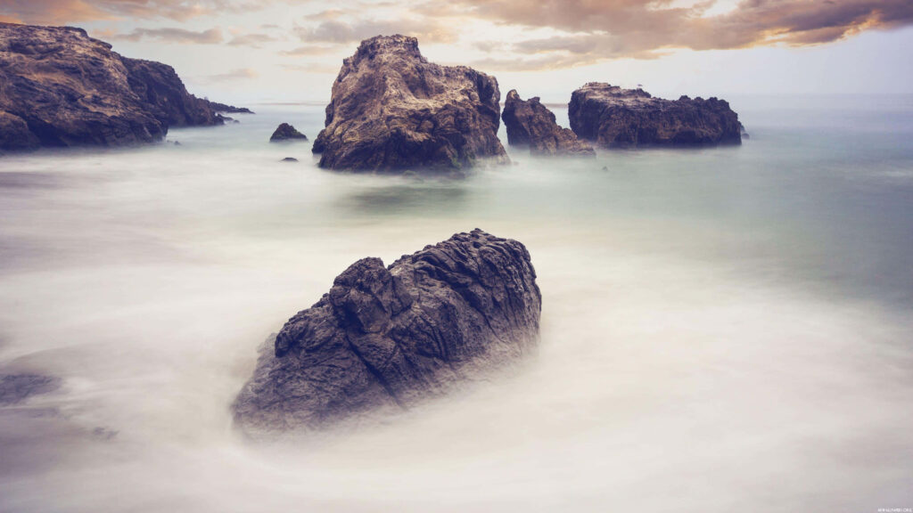 Stunning Seascape Wallpaper: Rugged Rocks & Misty Shoreline