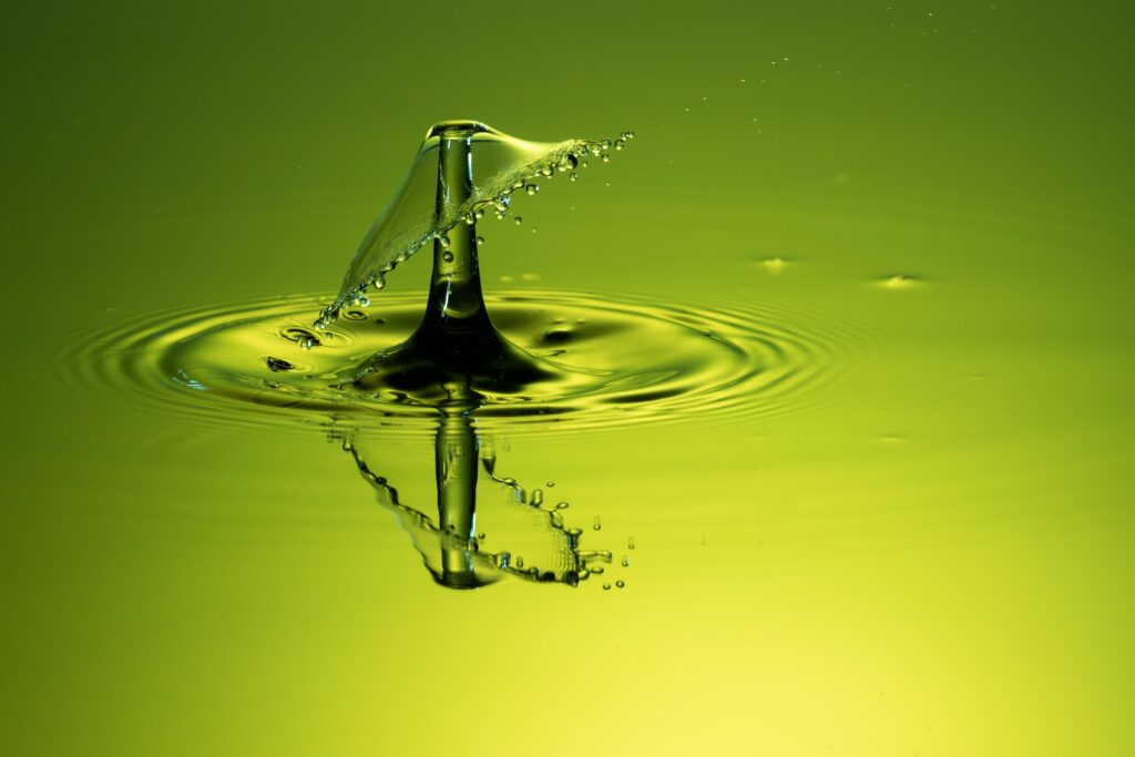 Vibrant Green Water Droplet Splash: Intricate Ripple Macro Wallpaper