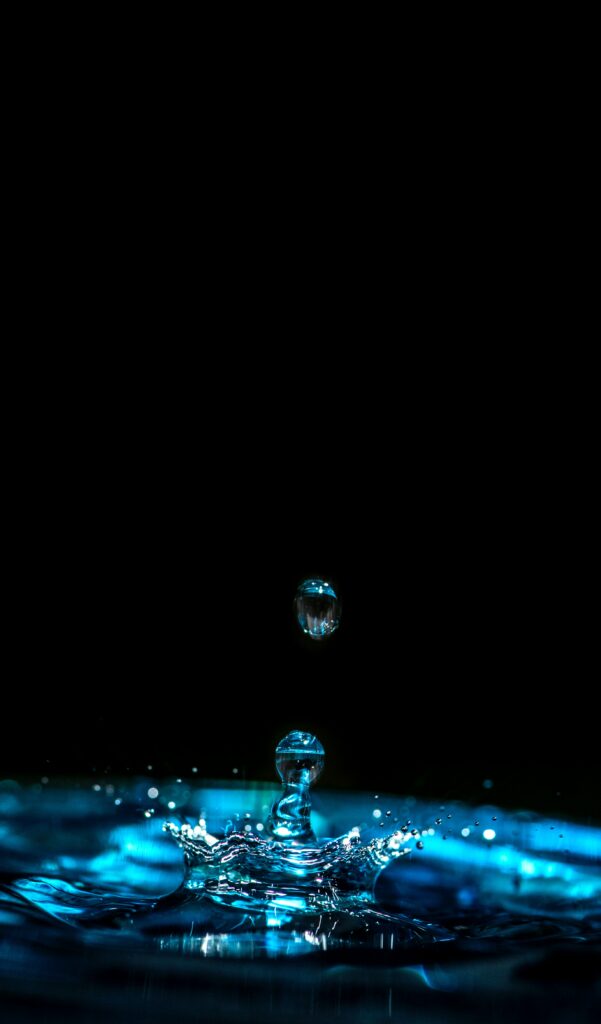 Mesmerizing Water Droplet Splash Wallpaper in Blue Tones