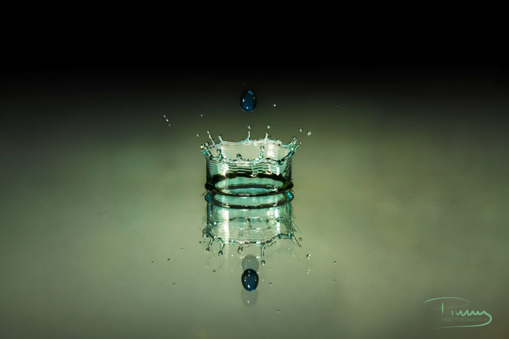 Intricate Water Droplet Splash Wallpaper Against Dark Background