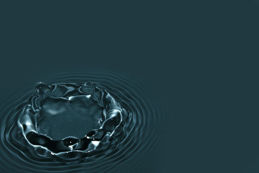 Mesmerizing Water Splash Wallpaper Against Dark Minimalist Background