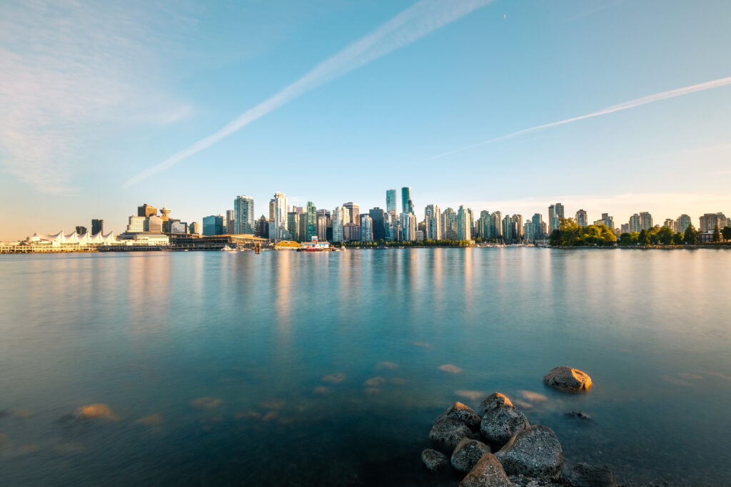 Tranquil Waterfront Cityscape Wallpaper: Modern Skyline Reflection
